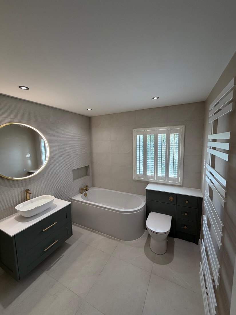Full bathroom refit with freestanding bath, brushed brass taps and LED mirror