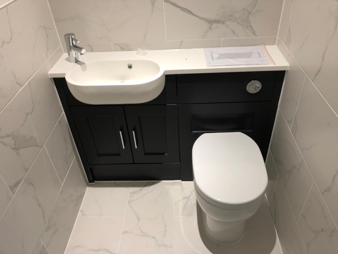 Compact cloakroom suite with combined vanity and concealed cistern