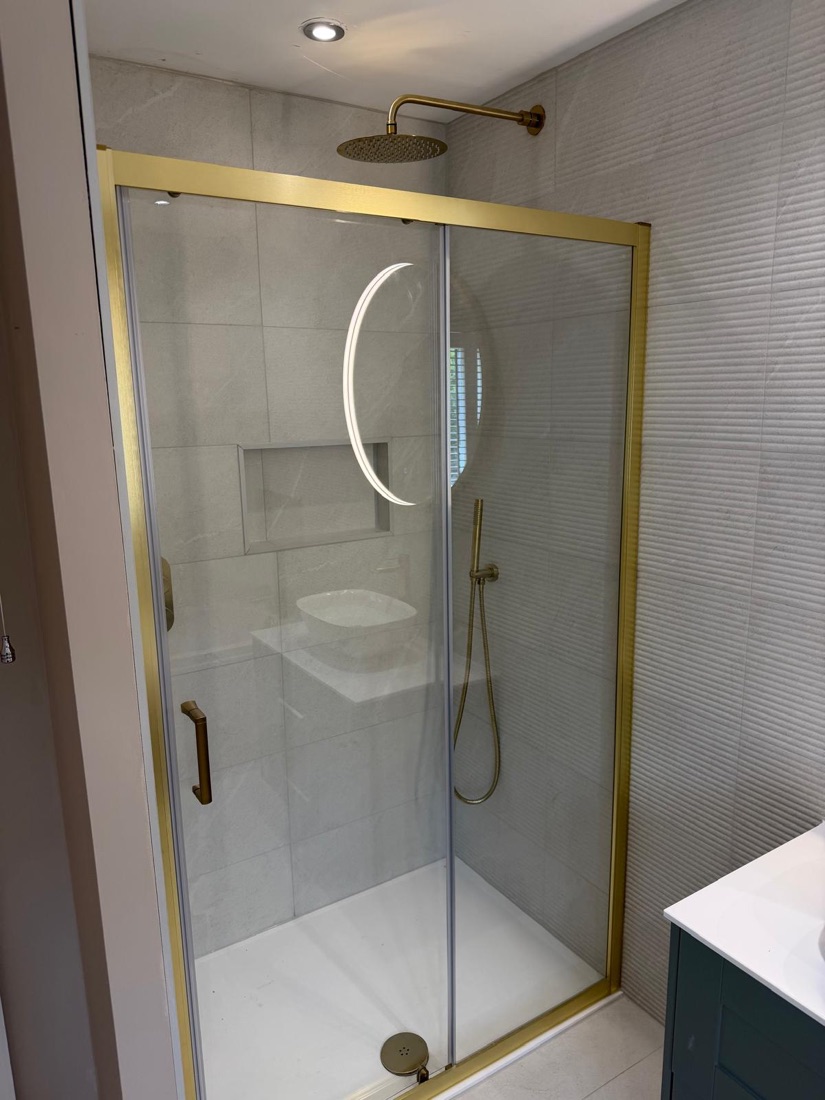 Shower enclosure with brushed brass frame and rainfall head